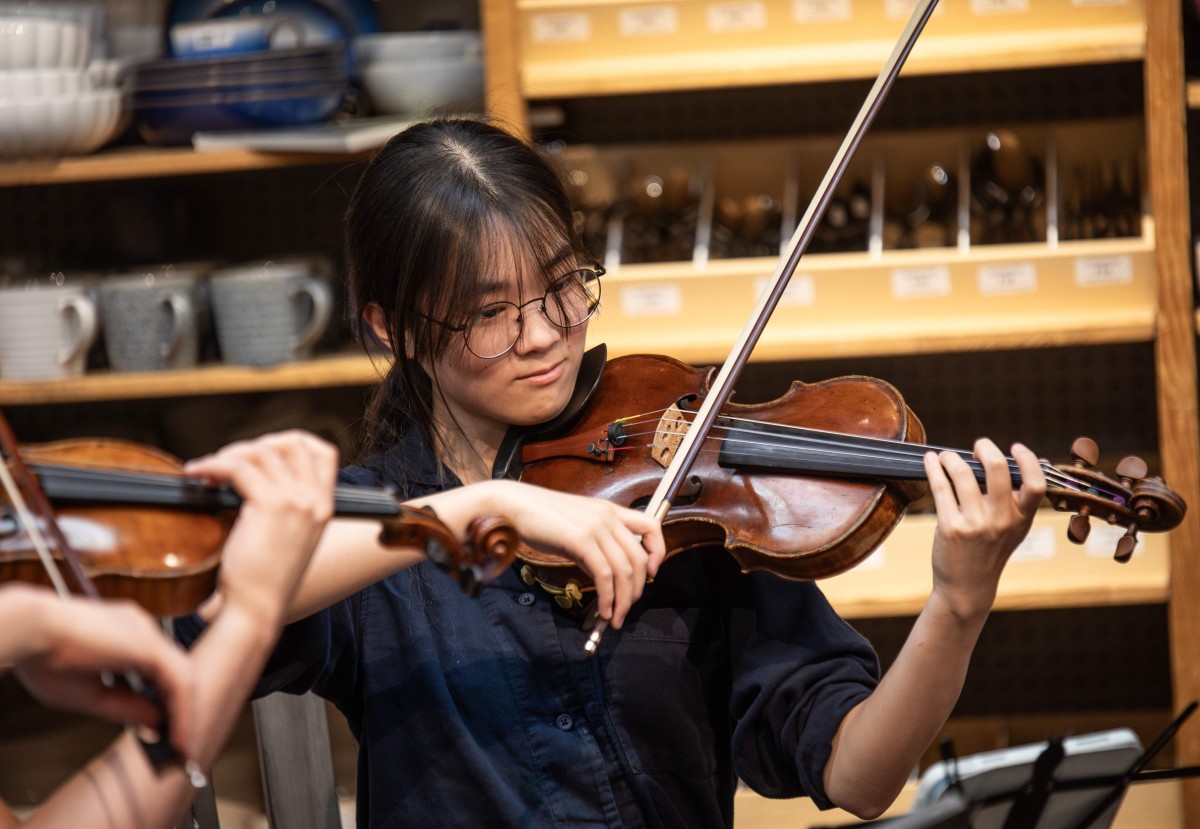 Close up shot of one violin student performing