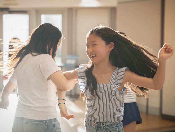 two students swing dancing and laughing