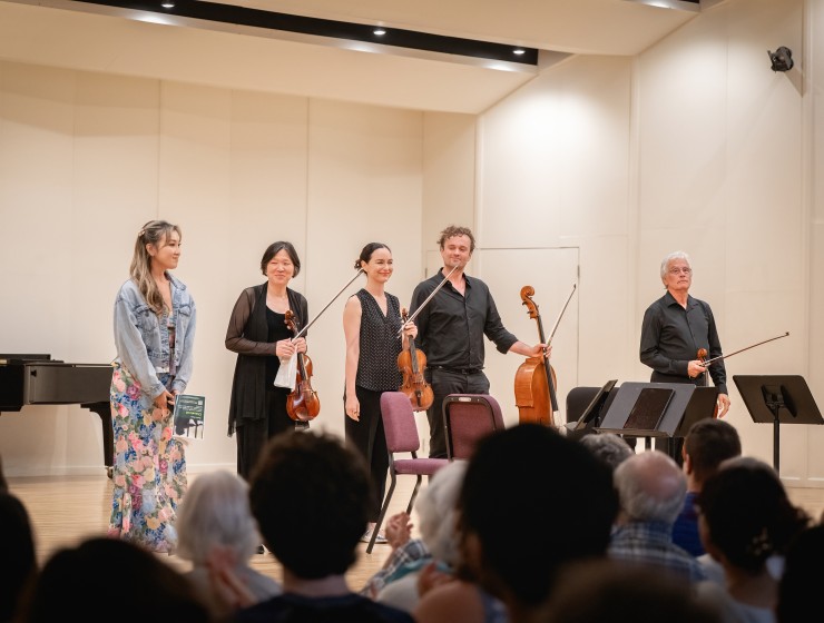 Nicky Sohn bows with four musicians on stage after premiering her piece