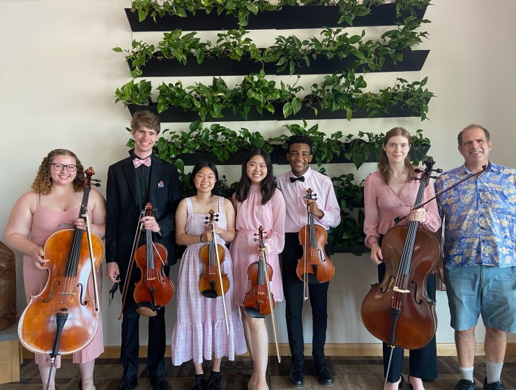 students posing with instruments