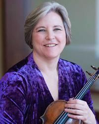 A woman in a purple velvet shirt holding a violin