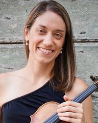 A woman with a one-shoulder black dress holding a violin